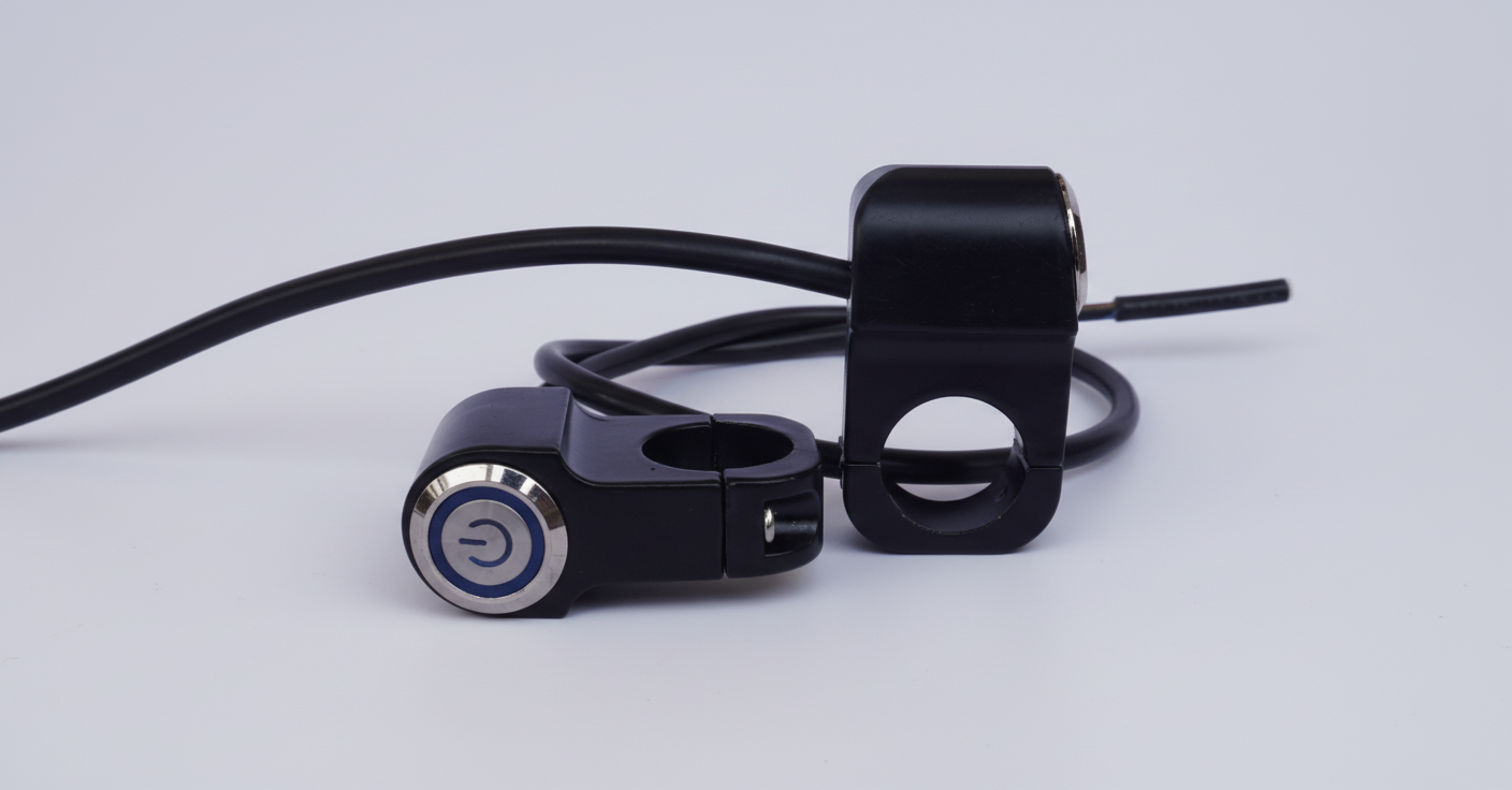 Black motorcycle handlebar control unit with cable on a light gray background