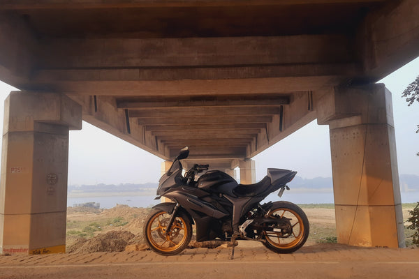 A motorcycle on an open road at sunset, symbolizing freedom and adventure.