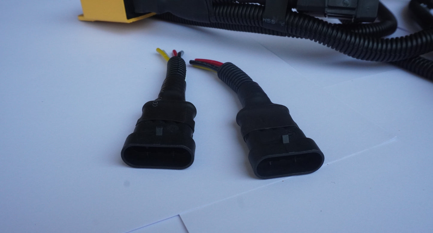Two black electrical connectors on a white surface