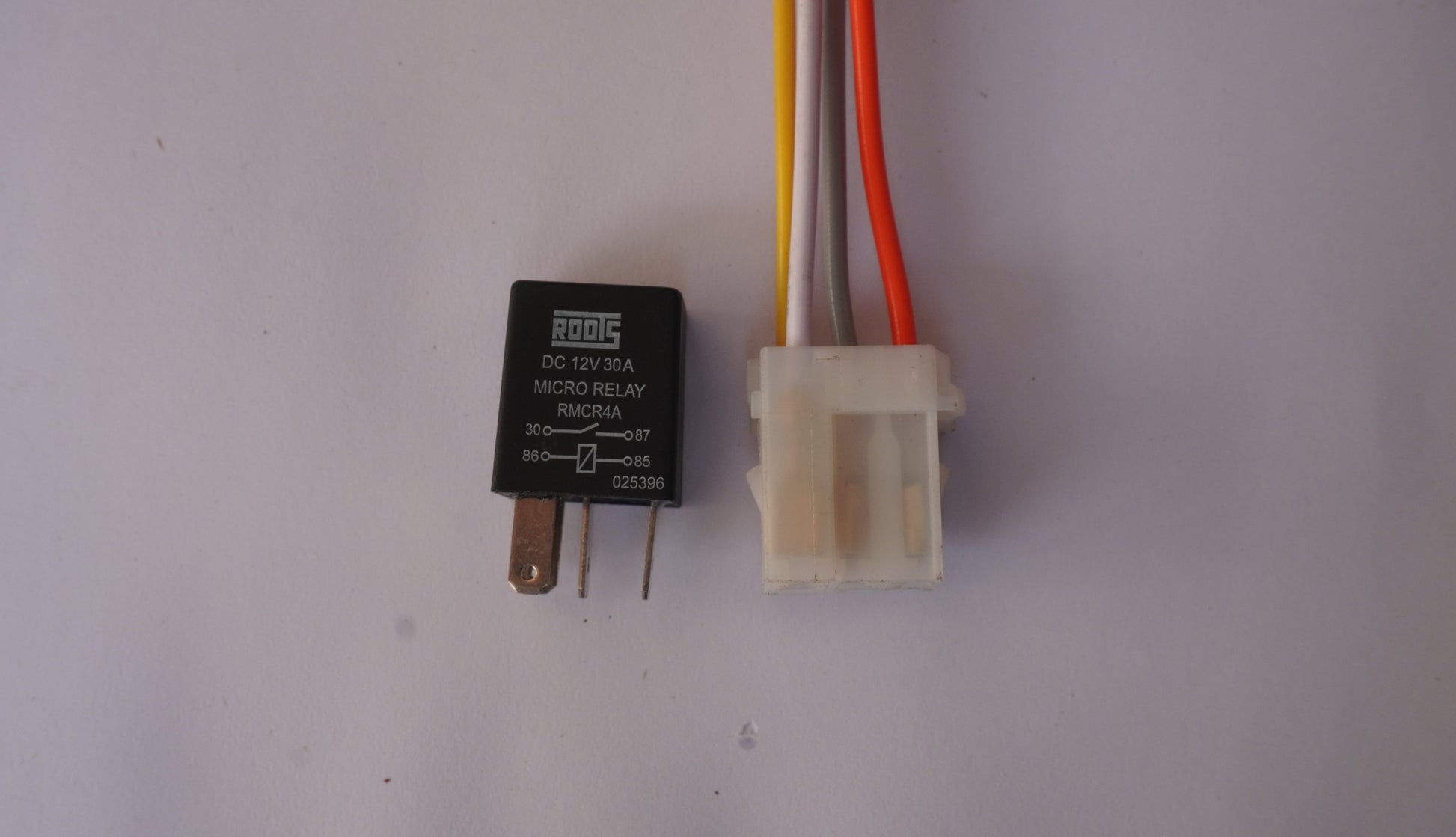 Relay with wiring connector on a plain background