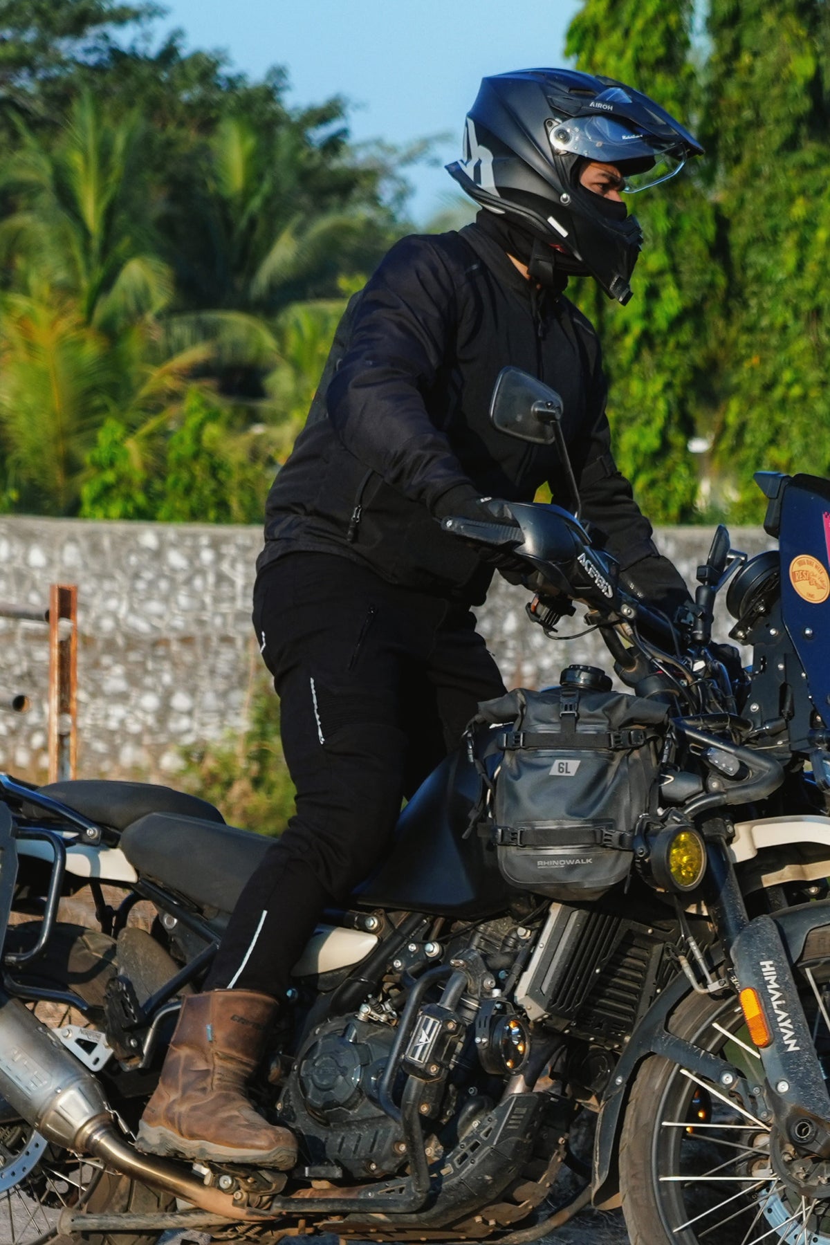 Rider wearing Rollin’Denims Genesis 2.0 Jet Black jeans while standing on a motorcycle’s foot pegs | MotoARZT