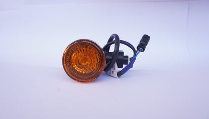Amber traffic light lens with wiring on a white background