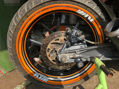 Wide orange portawall insert on KTM rear wheel showing bold orange sidewall stripe