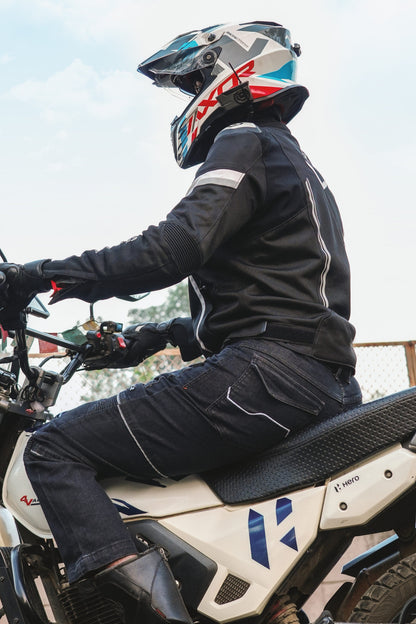 Rollin’Denims Outlaw charcoal black riding cargo pants, rear-side view on a seated motorcyclist, at MotoARZT.