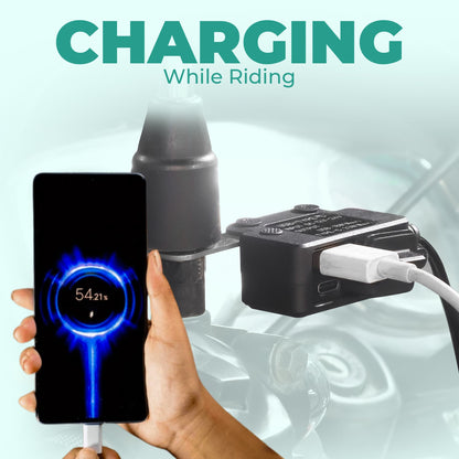 Hand holding a smartphone with a charging device attached, text 'Charging While Riding' above. | MotoARZT