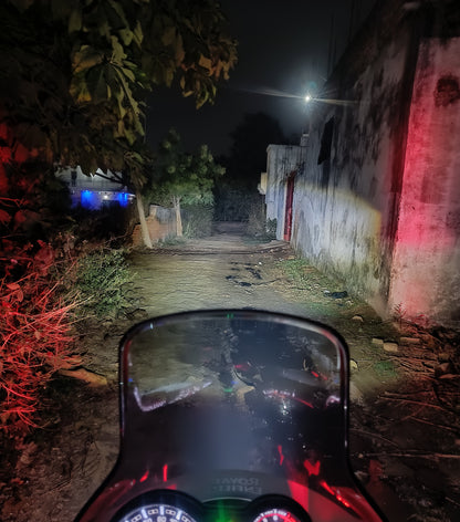 Royal Enfield Motorcycle dashboard view on a dark street with visible gauges and indicators.