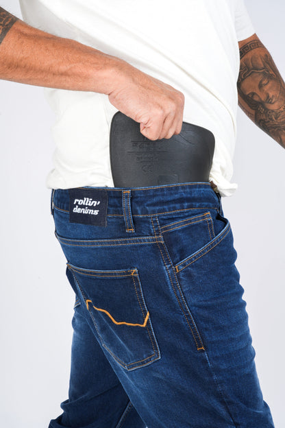 Shadow-2.0_07: Black hip protector being inserted into the internal hip pocket of Shadow 2.0 riding jeans, at MotoARZT.