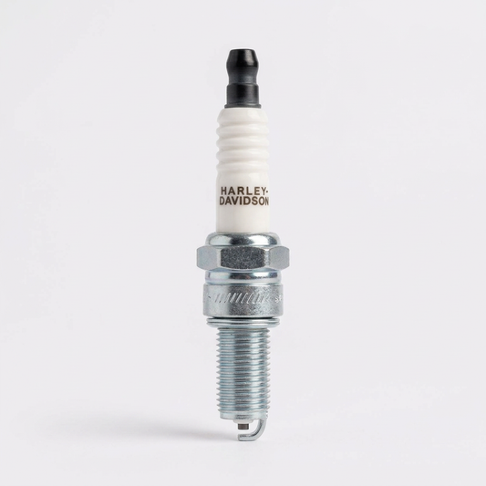 Single Harley-Davidson Street 750 spark plug with white ceramic insulator, black terminal and silver threaded electrode end.